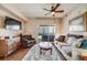 A living room features sliding glass doors, a ceiling fan, neutral colors and hardwood floors at 15700 E Jamison Dr # 6-101, Englewood, CO 80112