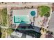 Aerial view of a community pool with lounge chairs and a circular green pool cover at 15700 E Jamison Dr # 6-101, Englewood, CO 80112