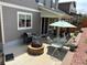Backyard patio with a grill, fire pit, seating area, and lush landscaping; perfect for outdoor entertaining and relaxation at 2115 Coach House Loop, Castle Rock, CO 80109