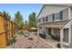 Large backyard featuring patio, firepit, landscaped garden, and fenced yard at 2115 Coach House Loop, Castle Rock, CO 80109