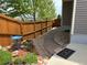 Well-manicured backyard path with wooden fencing, a blue bird bath, and lush garden landscaping at 2115 Coach House Loop, Castle Rock, CO 80109