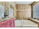 Bathroom featuring a tub, tiled walls, and a window for natural light at 2115 Coach House Loop, Castle Rock, CO 80109