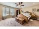 Comfortable bedroom featuring a wood bed frame, ceiling fan, and natural light from the window at 2115 Coach House Loop, Castle Rock, CO 80109