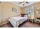 Bedroom with a cozy bed, side table, and a window with natural light at 2115 Coach House Loop, Castle Rock, CO 80109
