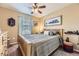 Comfortable bedroom with a bed, ceiling fan, and artwork on the walls at 2115 Coach House Loop, Castle Rock, CO 80109
