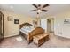 Bright bedroom featuring a ceiling fan, carpeted floors, and a comfortable bed at 2115 Coach House Loop, Castle Rock, CO 80109