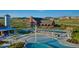 Community pool area with multiple pools, lounge chairs, and a large building, perfect for recreation at 2115 Coach House Loop, Castle Rock, CO 80109
