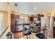 Modern kitchen featuring stainless steel appliances, dark wood cabinets, granite countertops and a center island with seating at 2115 Coach House Loop, Castle Rock, CO 80109