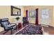 Cozy living room features hardwood floors, a decorative rug, modern seating, and lots of light from the large windows at 2115 Coach House Loop, Castle Rock, CO 80109