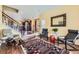 Inviting living room boasts hardwood floors, stairs to the left, modern seating, and decorative mirror at 2115 Coach House Loop, Castle Rock, CO 80109