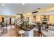 Spacious open-concept living room features a kitchen island with bar stools, fireplace, and hardwood flooring at 2115 Coach House Loop, Castle Rock, CO 80109