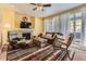 Cozy living room with a fireplace, ceiling fan, and sliding glass doors to the outside at 2115 Coach House Loop, Castle Rock, CO 80109