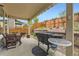 Covered patio area, ideal for outdoor dining and entertaining, with BBQ and ample seating at 2115 Coach House Loop, Castle Rock, CO 80109