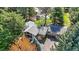 Aerial view of a home nestled amongst trees, with a well-maintained lawn and a detached garage at 182 Ridge Rd, Boulder, CO 80303