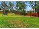 Spacious backyard with mature trees, trampoline, swing set, and wooden fence at 182 Ridge Rd, Boulder, CO 80303
