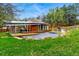 Expansive backyard featuring a modern pool with a solar panel shading system and a slide to the right at 182 Ridge Rd, Boulder, CO 80303