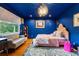 Stylish bedroom features an eye-catching chandelier, vibrant blue walls, and decorative rug at 182 Ridge Rd, Boulder, CO 80303