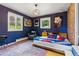 Spacious bedroom with hardwood floors, large windows, and unique decor at 182 Ridge Rd, Boulder, CO 80303