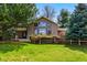 Inviting home showcasing large window, lush greenery, and well-maintained lawn at 182 Ridge Rd, Boulder, CO 80303
