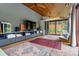 Bright living room featuring wood ceilings, sliding glass doors and modern decor at 182 Ridge Rd, Boulder, CO 80303