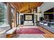 Open living room featuring wood ceilings, large windows, cozy seating, and stylish decor at 182 Ridge Rd, Boulder, CO 80303