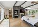 Large bedroom features dark accent wall with fireplace, TV and a seating area at 182 Ridge Rd, Boulder, CO 80303