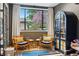 Cozy sitting room with large window, comfortable chairs, stylish cabinet, and beautiful backyard view at 182 Ridge Rd, Boulder, CO 80303