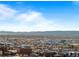 Scenic aerial view of the cityscape with the mountains in the distance under a blue sky at 891 14Th St # 3510, Denver, CO 80202