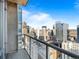 A balcony view shows the city skyline, with many buildings, streets, and a clear sky at 891 14Th St # 3510, Denver, CO 80202