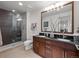 Modern bathroom featuring dual sinks, a walk-in shower with glass doors, and sleek fixtures at 891 14Th St # 3510, Denver, CO 80202