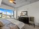 Bright bedroom with a large window showing city views, concrete ceiling, and carpet floors at 891 14Th St # 3510, Denver, CO 80202