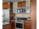 Modern kitchen featuring stainless steel appliances, stylish cabinetry, and updated backsplash at 891 14Th St # 3510, Denver, CO 80202