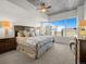 Cozy main bedroom features a large window with city views, a ceiling fan, and plush bedding at 891 14Th St # 3510, Denver, CO 80202