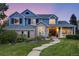 Charming two-story blue home with a landscaped front yard and inviting entryway at 1496 Meyerwood Cir, Highlands Ranch, CO 80129