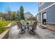 Inviting patio with a round table and seating, surrounded by colorful landscaping and access to the home at 1496 Meyerwood Cir, Highlands Ranch, CO 80129