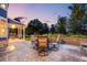 Sunset view of an outdoor patio featuring a dining table and chairs, ideal for enjoying a meal outdoors at 1496 Meyerwood Cir, Highlands Ranch, CO 80129