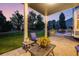 Relaxing covered patio with seating area, a beautiful backyard and manicured landscaping at 1496 Meyerwood Cir, Highlands Ranch, CO 80129