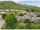 Aerial view of townhomes with lush green hillside in the background offering a serene and picturesque setting at 6948 Buckskin Dr, Littleton, CO 80125