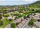 Scenic aerial view of a neighborhood nestled among rolling hills and lush greenery, showcasing a peaceful residential setting at 6948 Buckskin Dr, Littleton, CO 80125