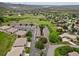 Panoramic aerial view featuring townhomes and residences in a lush, green landscape with a clear view of the distant plains at 6948 Buckskin Dr, Littleton, CO 80125