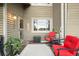 Cozy back patio with comfortable seating, ideal for enjoying the outdoors, decorated with red patio furniture at 6948 Buckskin Dr, Littleton, CO 80125
