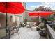 Inviting deck with outdoor seating, perfect for relaxation and gatherings with red umbrellas at 6948 Buckskin Dr, Littleton, CO 80125