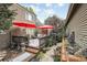 Beautiful backyard deck with red umbrellas, featuring ample space for outdoor seating and entertaining at 6948 Buckskin Dr, Littleton, CO 80125