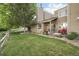 Lush backyard with green grass and a patio, creating a private outdoor retreat for relaxation and enjoyment at 6948 Buckskin Dr, Littleton, CO 80125