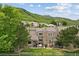 Inviting backyard with a small patio and a wooden fence providing privacy and views of the green hillside at 6948 Buckskin Dr, Littleton, CO 80125