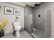 Contemporary bathroom featuring stylish gray tile, a sleek shower, and modern fixtures at 6948 Buckskin Dr, Littleton, CO 80125