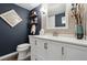 Chic powder room with white vanity, floating shelves, and modern framed art for a stylish touch at 6948 Buckskin Dr, Littleton, CO 80125