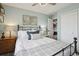 Comfortable bedroom with ceiling fan, closet and adjacent room, featuring a wrought iron bed frame at 6948 Buckskin Dr, Littleton, CO 80125