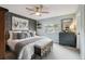 Well-appointed bedroom featuring accent wall, bench, dresser, and plenty of natural light at 6948 Buckskin Dr, Littleton, CO 80125