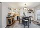 Bright dining area with a round table, stylish decor, and a convenient built-in bar and storage at 6948 Buckskin Dr, Littleton, CO 80125